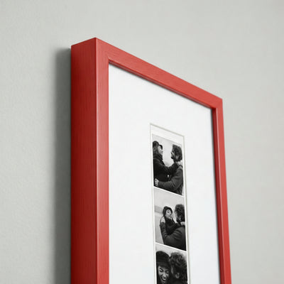Photo strip in a red wood frame