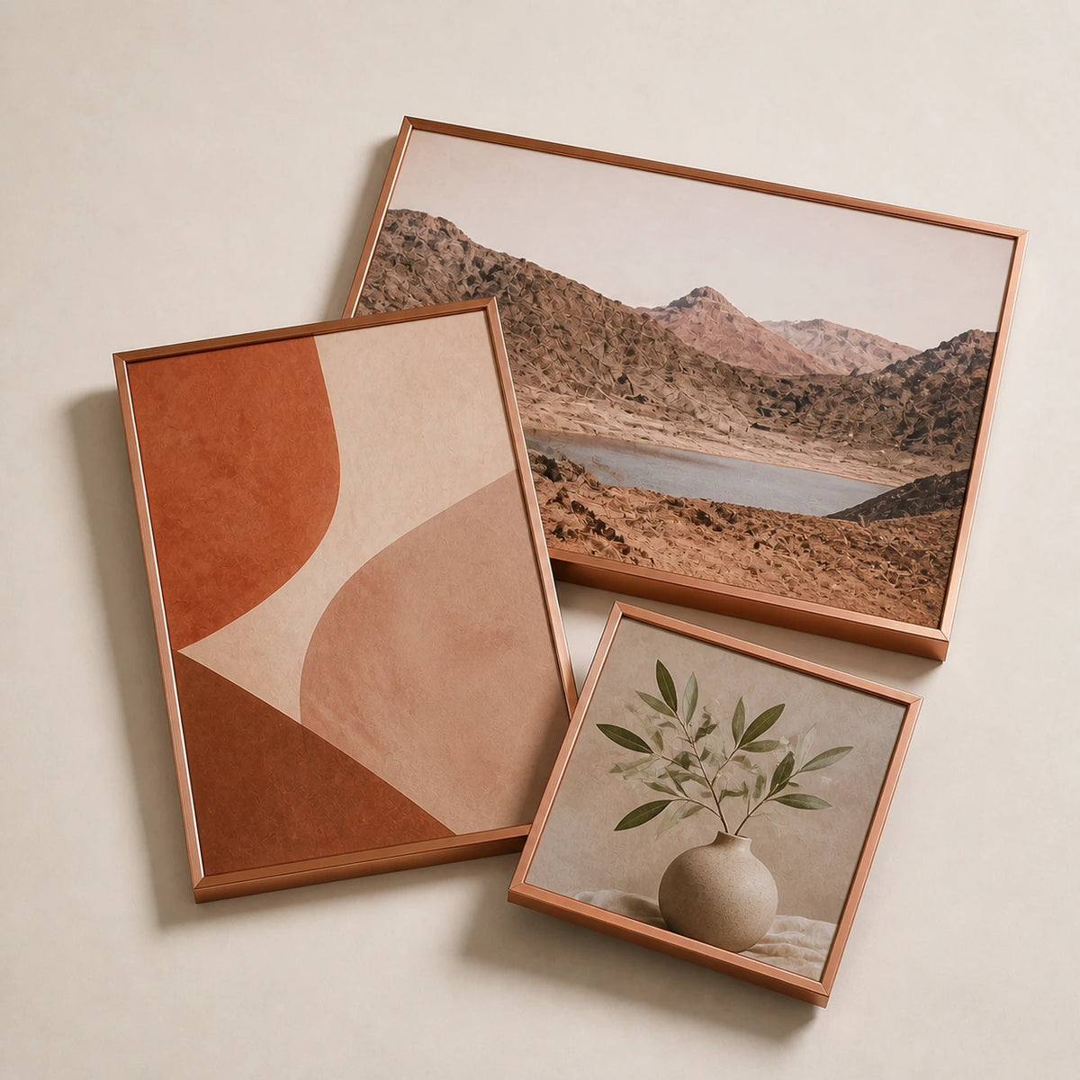 A collection of slim brushed copper picture frames lying flat with varied edge-to-edge artwork