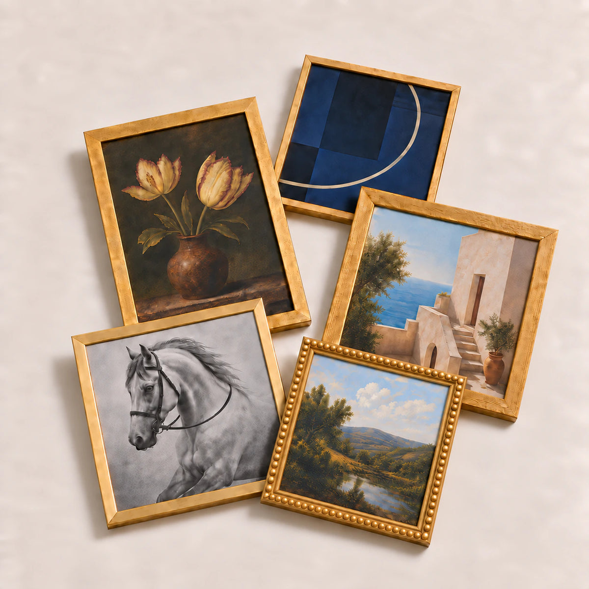 A collection of gold picture frames lying flat with varied edge-to-edge artwork