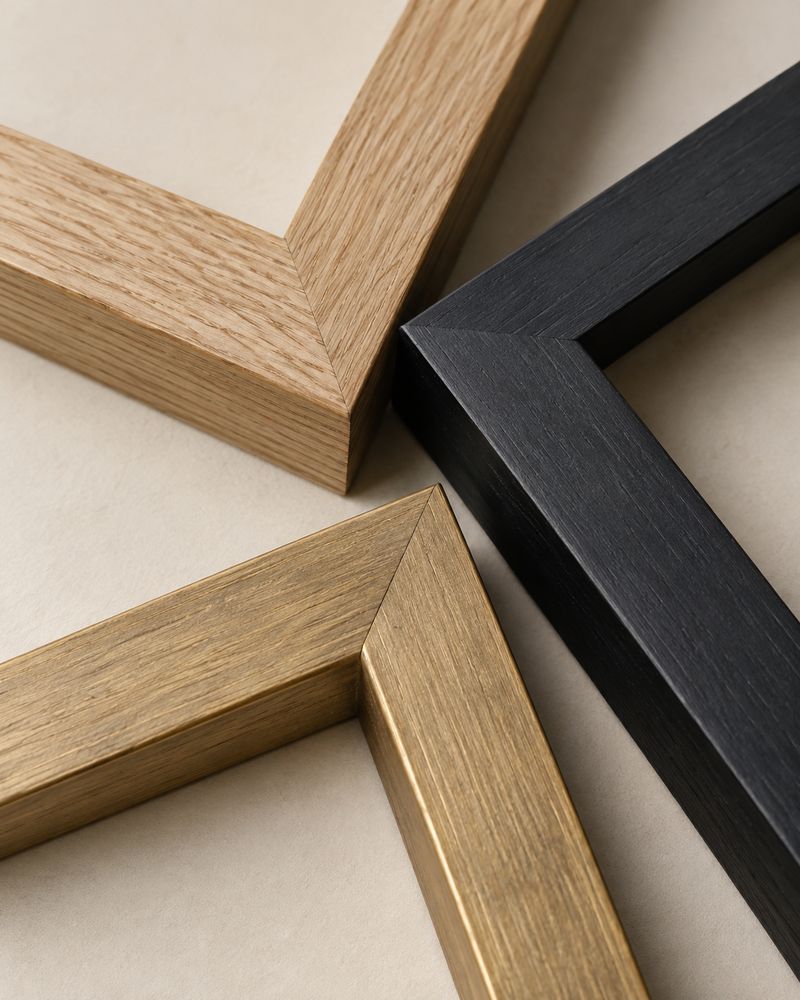 Generated close-up of natural wood, black and gold-tone picture-frame corners on a warm neutral surface