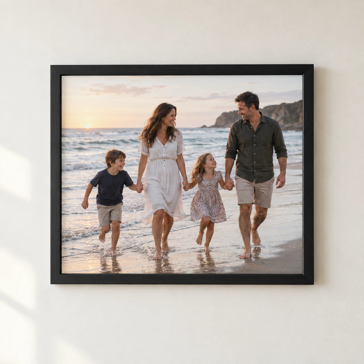 A family beach photograph printed edge to edge in a black frame without a mount