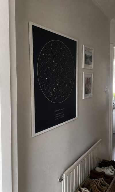 Personalised framed star map displayed in a hallway gallery