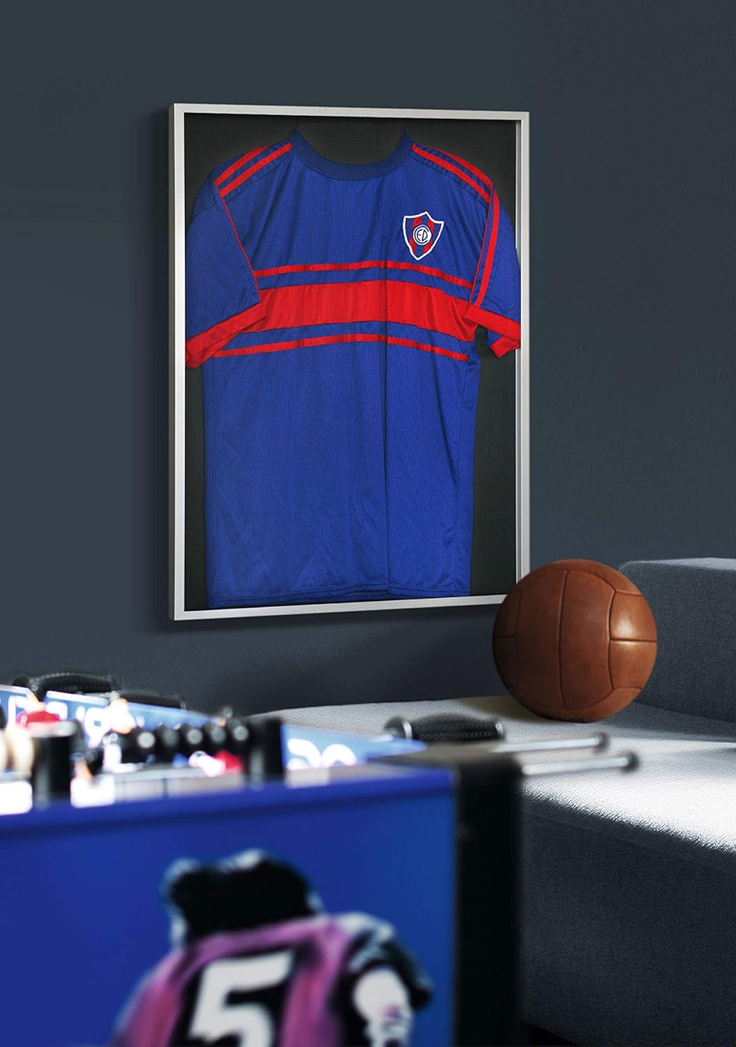 Framed football shirt on wall