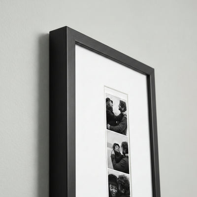 Photo strip in a black wood frame