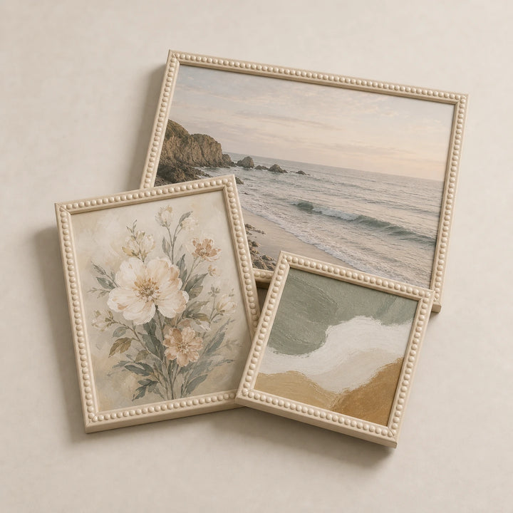 A collection of cream bobbin picture frames lying flat with varied edge-to-edge artwork