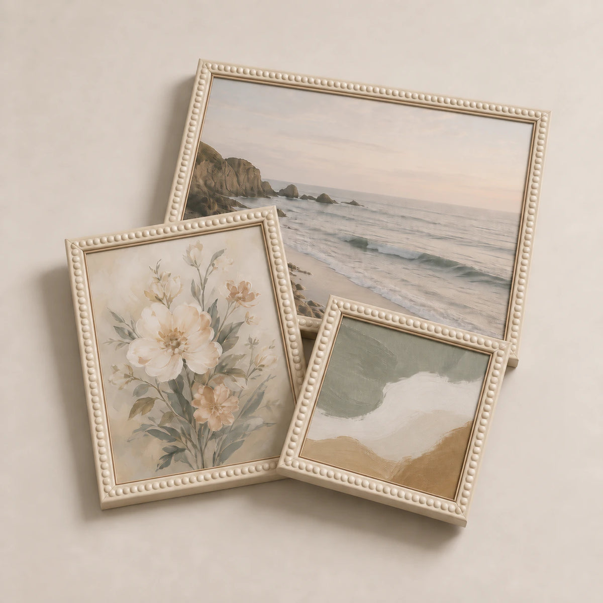 A collection of cream bobbin picture frames lying flat with varied edge-to-edge artwork