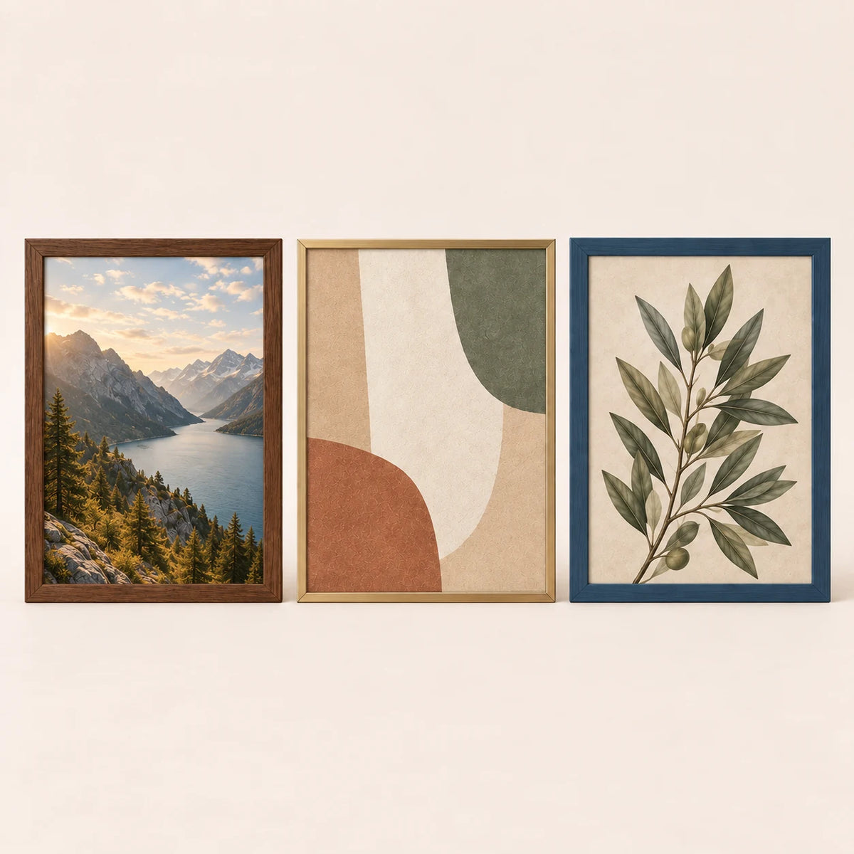 Three 20 by 27 inch picture frames in walnut, champagne brass and slate blue finishes with varied artwork